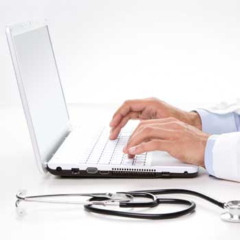 Doctor using laptop computer.