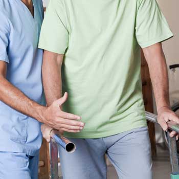 Patient walking with walking aid after surgery.