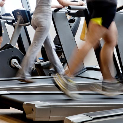 Image of patients walking on treadmills for rehabilitation after partial knee replacement surgery.